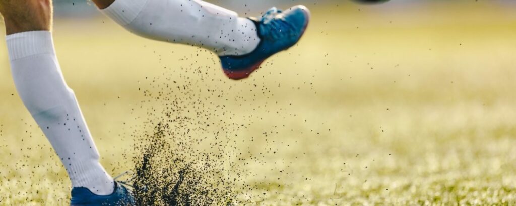 Soccer Player Kicking Ball on Synthetic turf